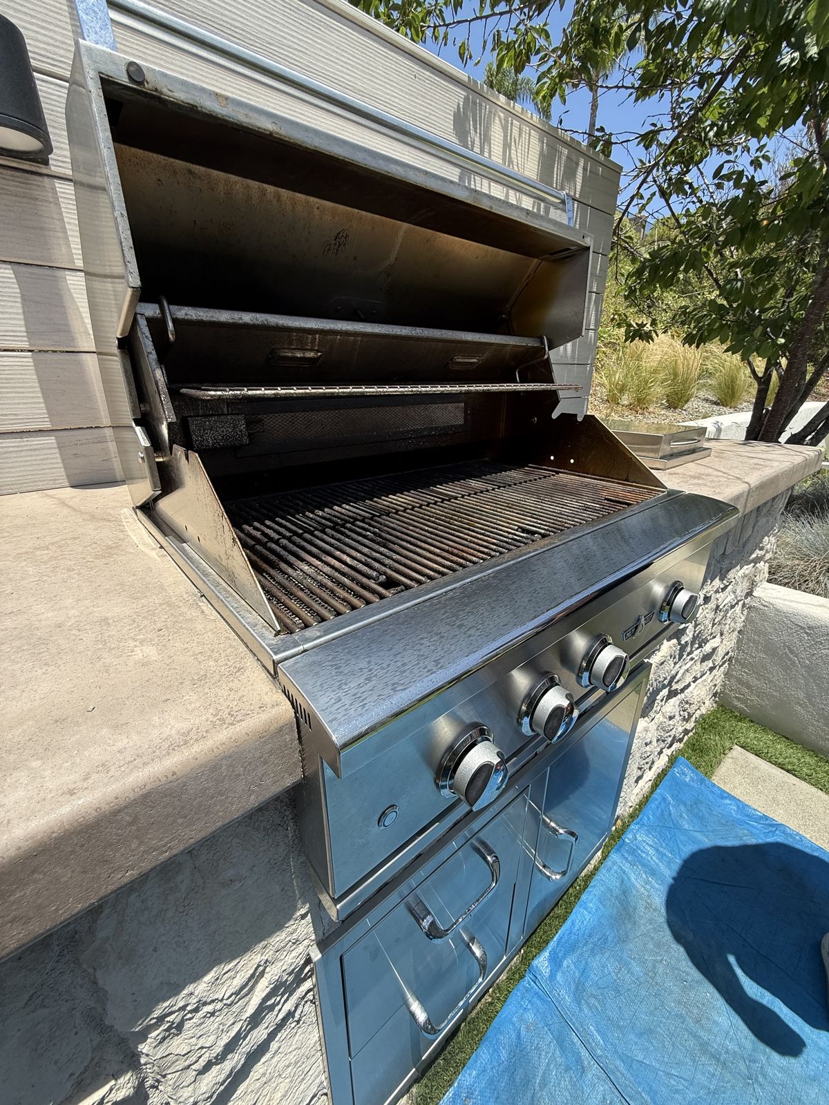 Grill interior mid-service, burners and grates exposed