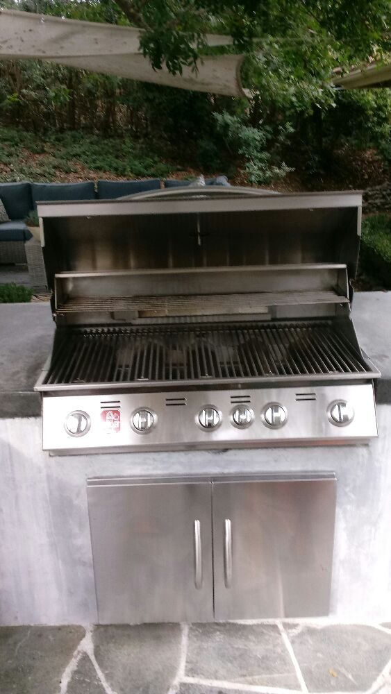 Newly installed built-in grill on a backyard patio